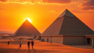 Tourists admiring the majestic piramids against a vibrant sunset backdrop.